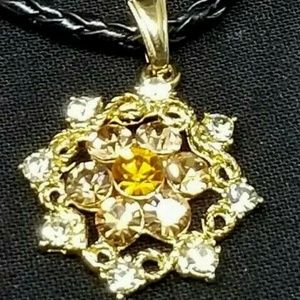 Faux costume jewelry flower rhinestone pendant